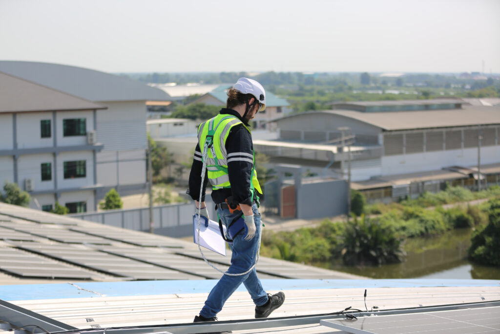 A professional inspecting a residential roof.